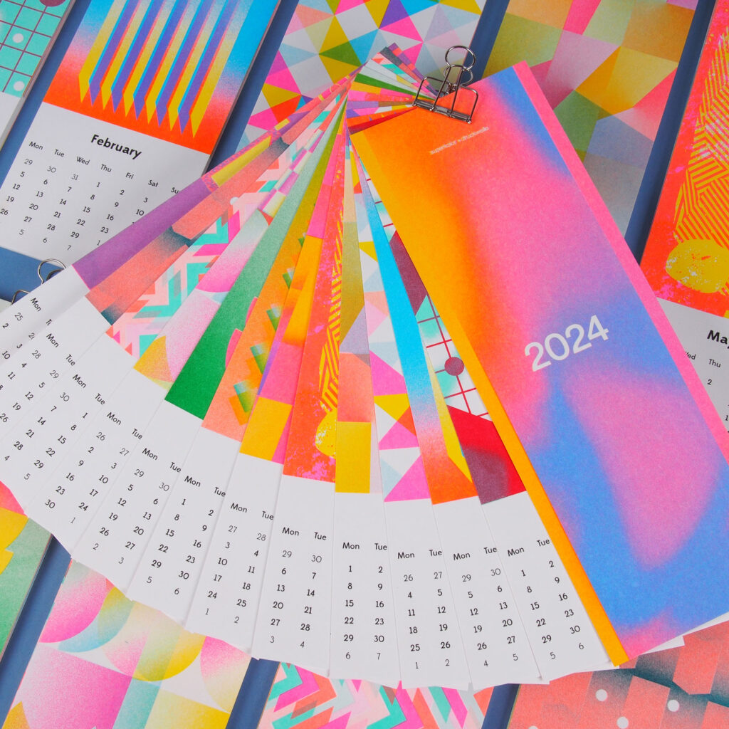 Gradient-style graphic design trend calendar, fan, and book in bright colors.